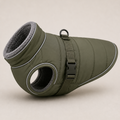 An olive green dog winter bootie with a gray fleece lining, featuring a strap closure and a circular opening on the side, shown on a neutral beige background.